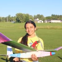 Student poses with her plane
